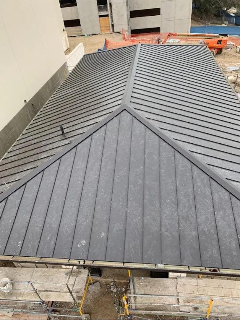 Commercial metal roof construction with crane equipment in Perry Hall