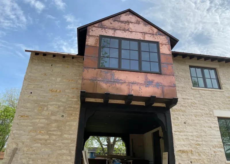 Copper metal panel facade on a stone building for Skylight Installation in Perry Hall